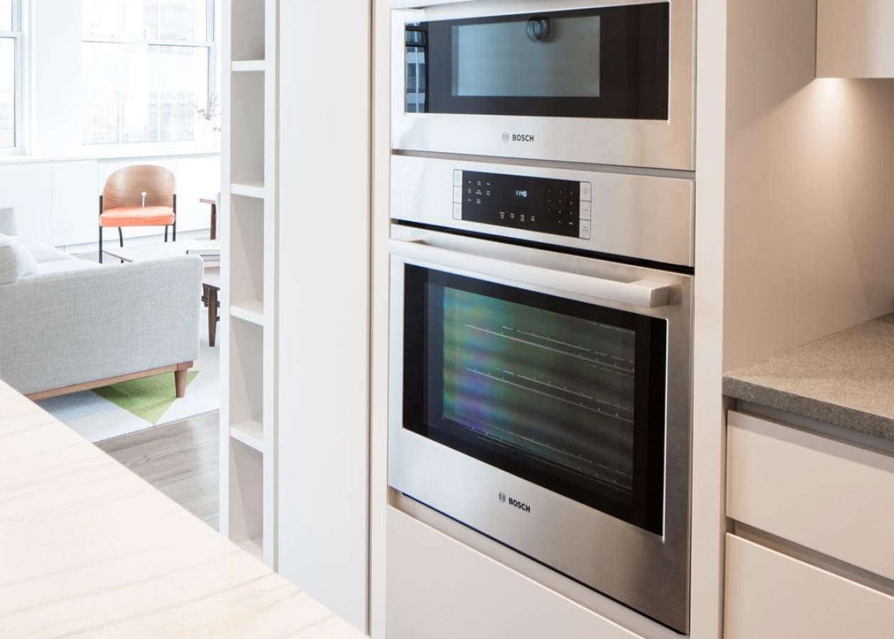 Modern built-in oven in a sleek white kitchen.