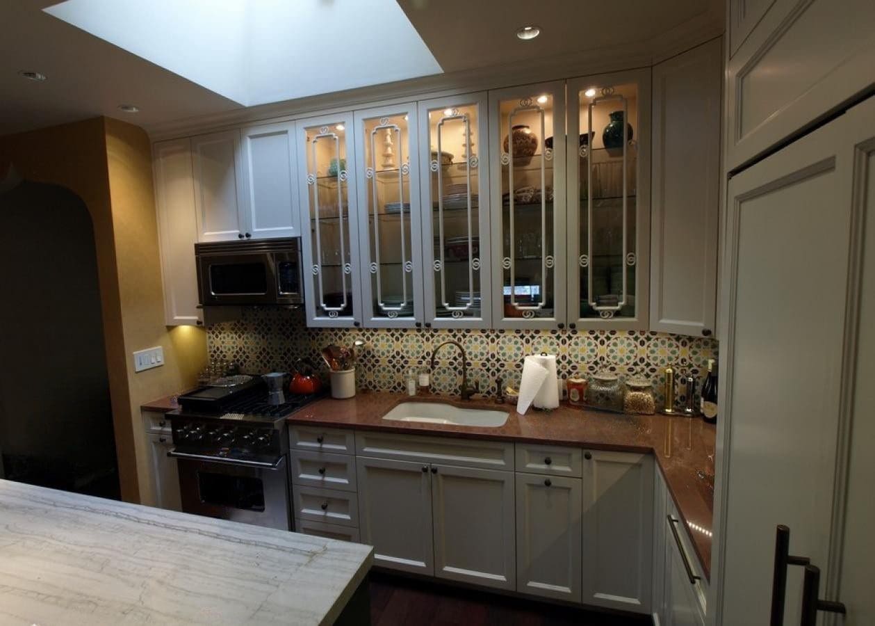 Cozy kitchen with white cabinets and warm lighting.