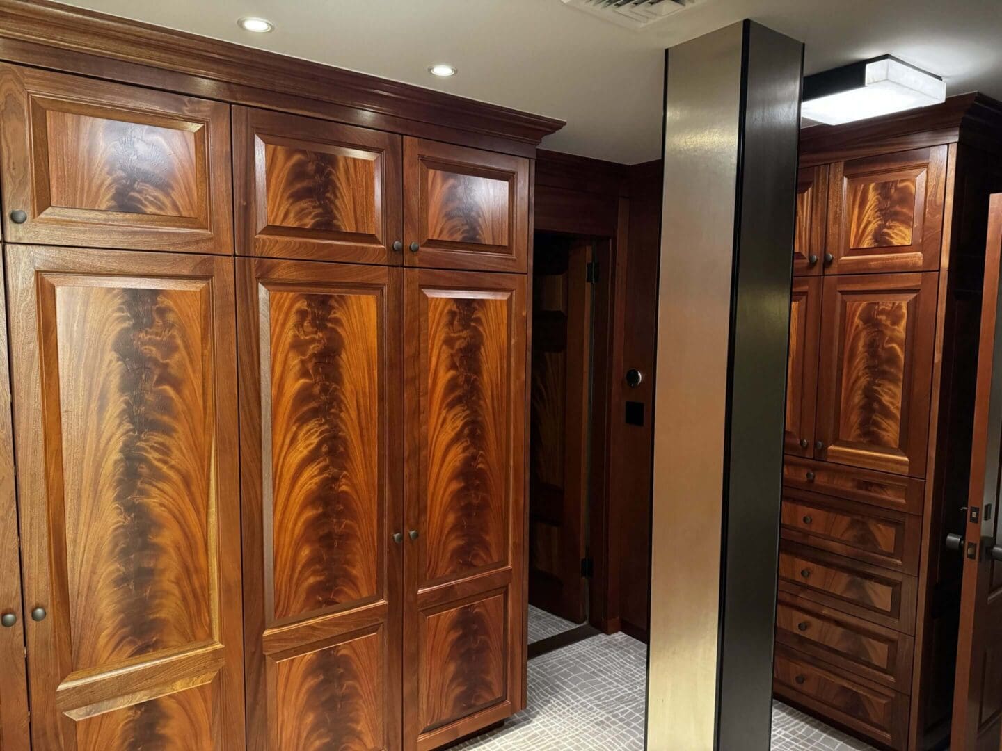 Elegant wooden wardrobe with intricate grain patterns in a cozy room.