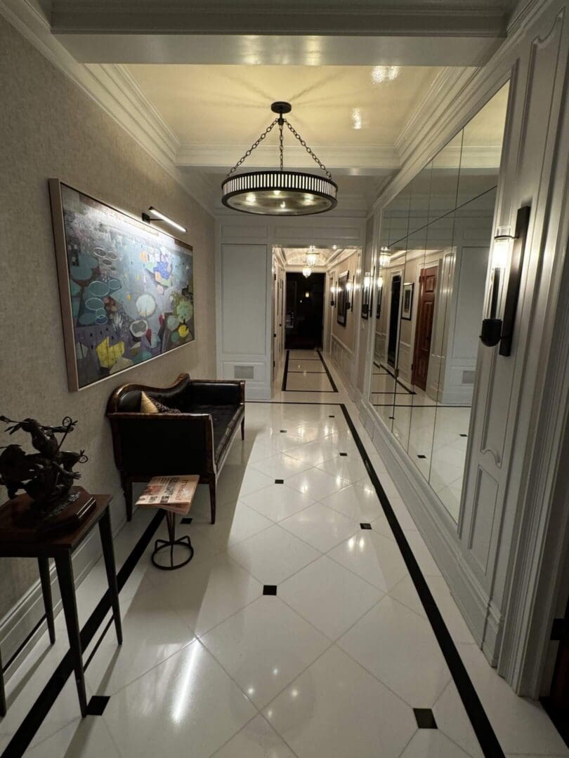 Elegant hallway with polished marble floors and a large world map on the wall.