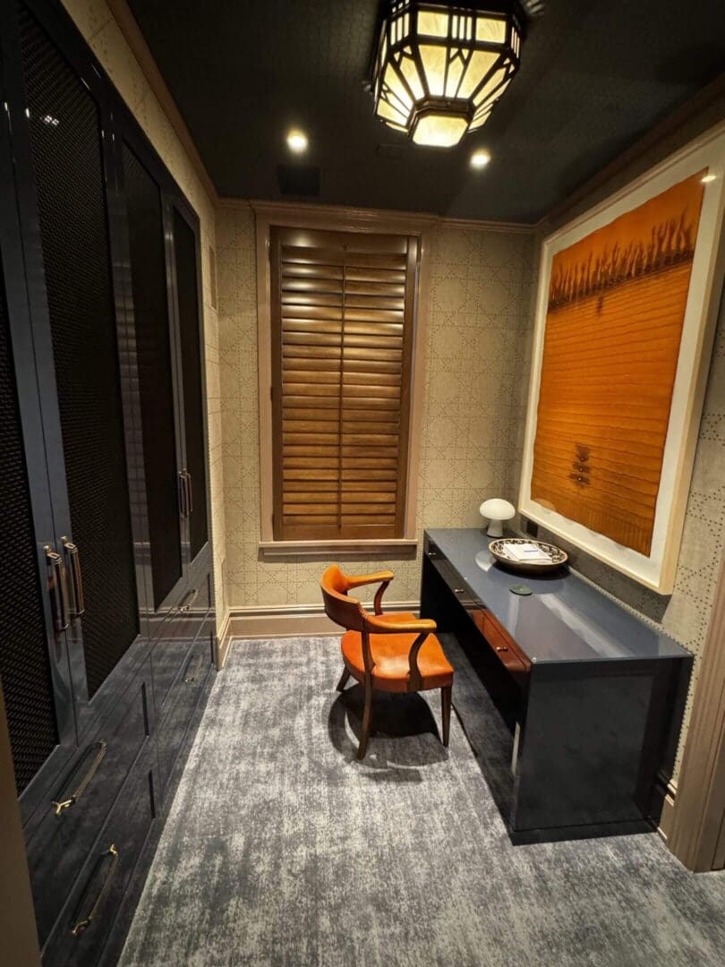 Cozy modern study room with wooden blinds and an elegant desk.