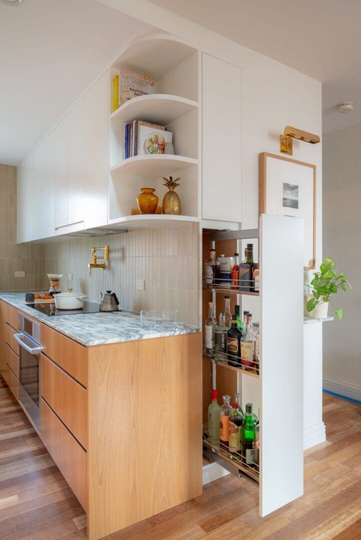 Modern kitchen with wooden cabinets and marble countertops.