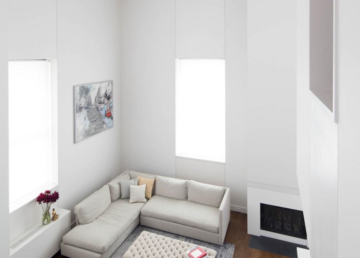 Bright modern living room with large window and cozy sectional sofa.