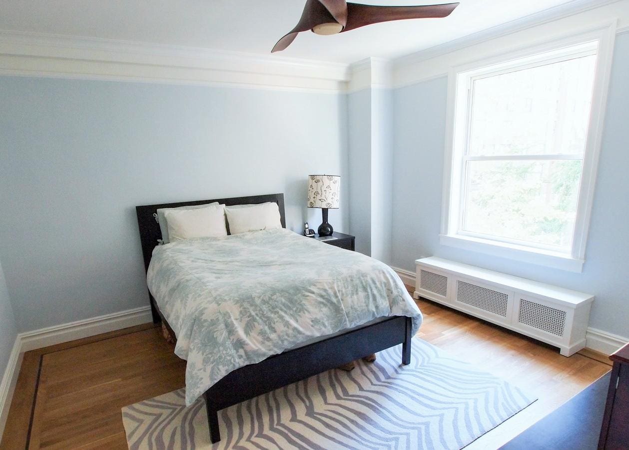 Minimalist bedroom with a large bed and natural light.