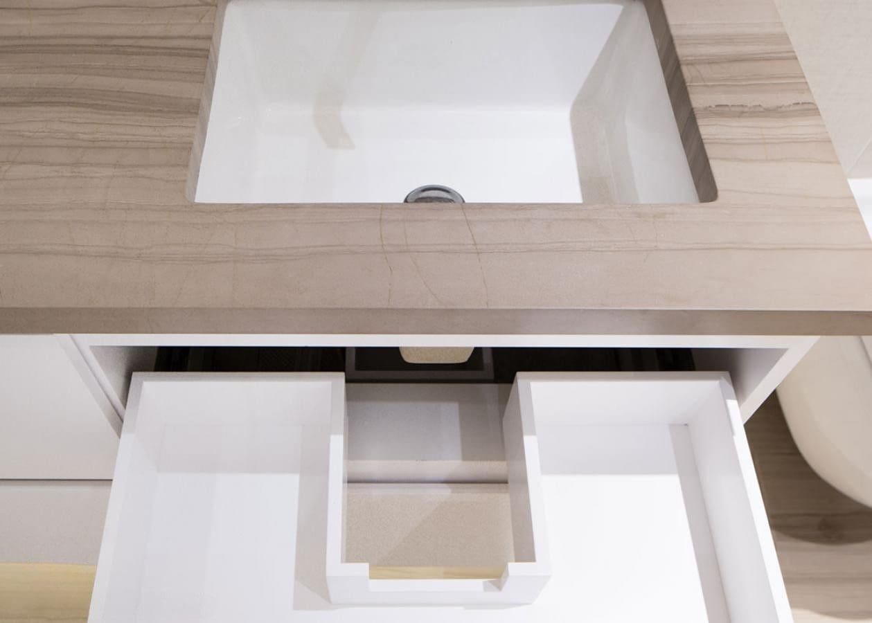 Modern rectangular sink with wooden countertop and clean, white basin.