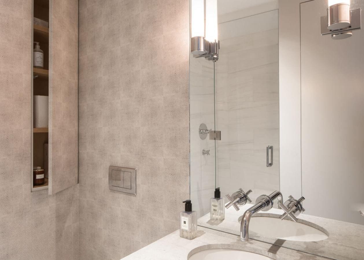 Modern bathroom with glass shower and sleek fixtures.