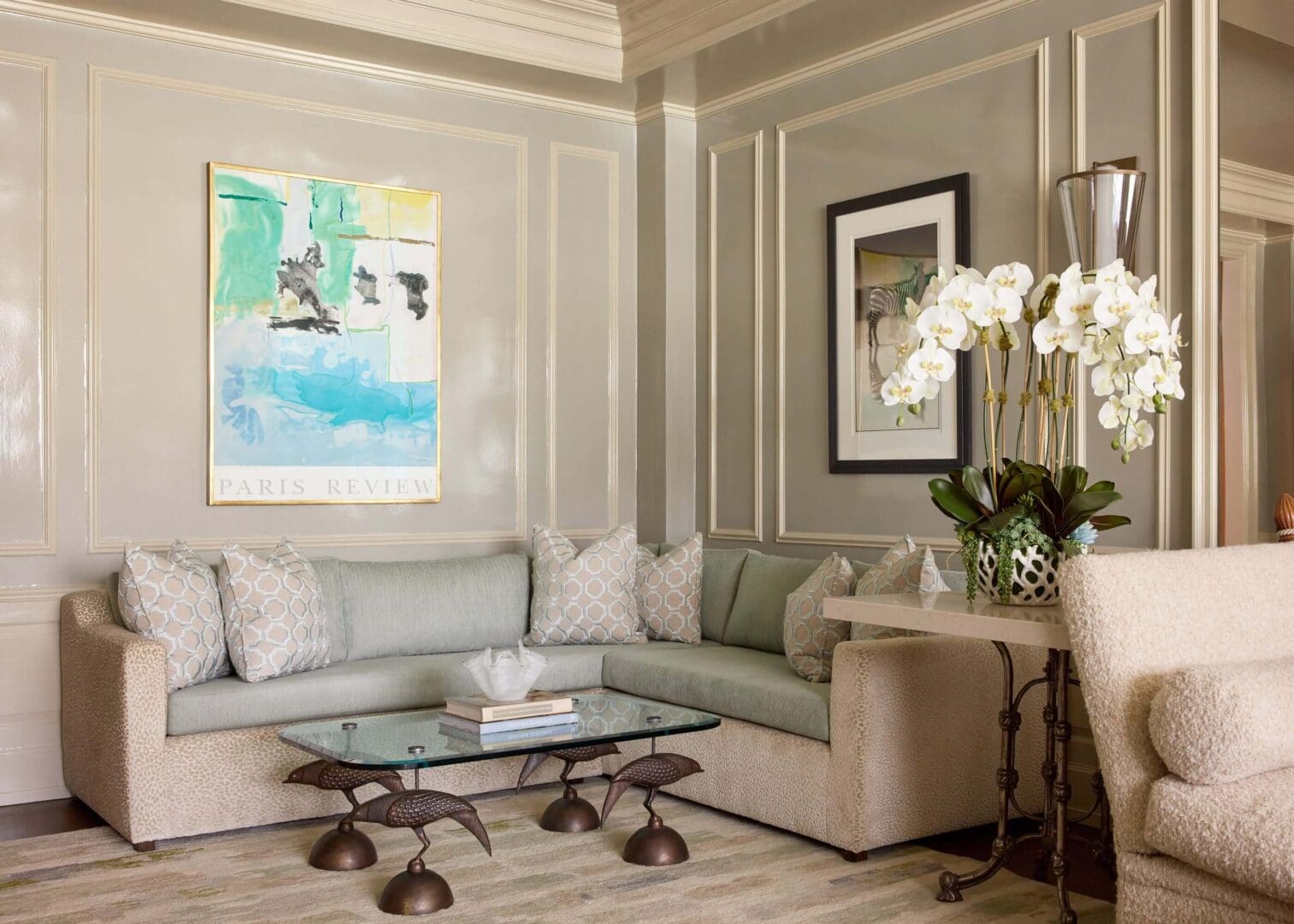 Elegant living room with neutral tones and modern art.