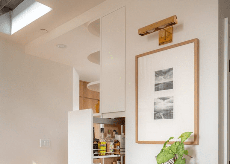 Cozy kitchen pantry with organized shelves and framed artwork on the wall.